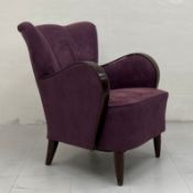 A 1960s Danish style armchair having a scalloped wing back with curved bentwood arms over a deep