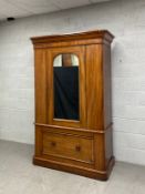 A 19th century mahogany wardrobe in three parts having a moulded cornice and crossbanded frieze over