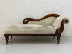 A 19th century walnut chaise longue having a scrolling carved openwork back and side with a