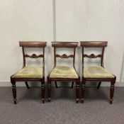 A set of three Regency bar back dining chairs each having a shaped top rail over a carved
