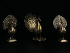 A pair of 19th century Indian white metal Kutch silver repousse peacocks along with a white metal