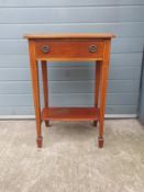 An Edwardian mahogany side table having a serpentine fronted thumb moulded top over a single