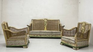 An early 20th century hand painted and lacquered three piece Bergere suite having a shaped back with