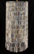 A contemporary chandelier having a circular chrome armature with eight stepped pendant light