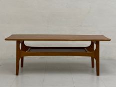 A 1960s Danish style teak coffee table having a shaped top raised on flat curved openwork trestle