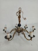A gilt metal chandelier in the French 19th century style having a central figural putto stem leading