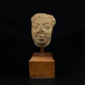 An Indian possibly Gupta period carved sandstone figural bust or head raised on a museum style