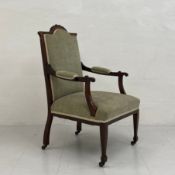 A 19th century mahogany armchair having a carved and shaped top-rail with a mint green velour