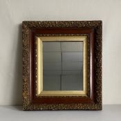 A late 19th century wall hanging mirror having a rectangular plate in a gilt moulded mahogany frame.