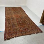 A very large 19th century Afghan runner carpet having three central lozenge medallions surrounded by