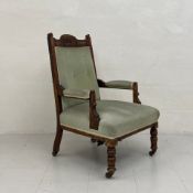 A 19th century walnut armchair having a carved and shaped top-rail with a mint green velour