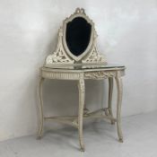 A painted wooden dressing table in the French 19th century style having a shield shaped swing mirror