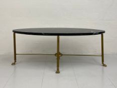 A 20th century French style coffee table of elliptical form having a black marble top raised on four