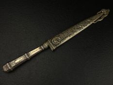 A 20th century western Goucho knife having a scrolling foliate repousse sheath and handle with a