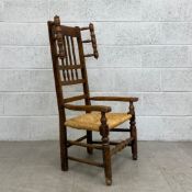 A 19th century elm Lancashire armchair having a curved top rail with a slatted and bobbin turned