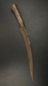 An early 20th century dagger having a curved steel blade with fluted fullers mounted with a brass