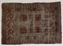 A 19th century Baluch rug having a central Mihrab surrounded by repeating geometric patterns over
