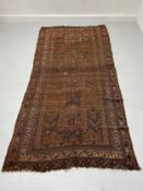 A large 19th century Baluch runner having four central lozenge medallions surrounded by all-over