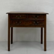 A Georgian walnut lowboy or side table having a rectangular thumb-moulded top over an arrangement of