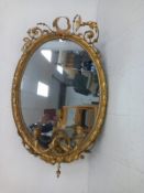 A 19th century Rococo style girandole mirror having the original oval plate in a moulded gilt