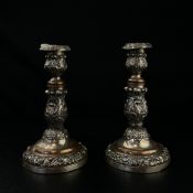 A pair of silver plated telescopic candlesticks each having a cast acanthus leaf candle holder