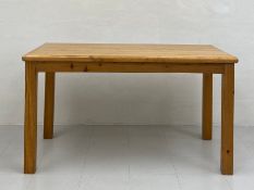 A vintage pine dining table having a simple rectangular top raised on straight square supports. H.75