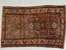 A 20th century Baluch rug having four central lozenge medallions surrounded by all-over geometric