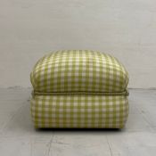 A vintage footstool on castors of square form in a green gingham upholstery bound in the middle with