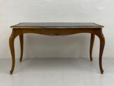 A large 19th century French mahogany writing desk or bureau plat having a shaped, tooled and gilt