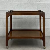 A 19th century mahogany two tier table having a rectangular tray top raised on four straight