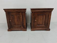 A pair of contemporary mango wood bedside cabinets each having a dentil moulded cornice over a