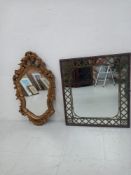 A contemporary Rococo style gilt plaster wall mirror having a shaped plate in a scrolling open-