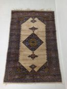 A Persian Serab rug having a central polychrome diamond lozenge medallion with four stepped