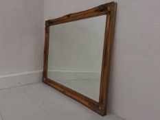 A large contemporary mirror in the French 19th century style having a rectangular plate in an ornate