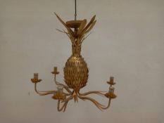 A contemporary gilt metal chandelier having a central naturalistic sheet metal pineapple stem with