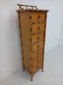 A 1980s Harrods style beech and faux bamboo narrow chest of drawers having a square top with an