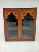 A C.1900 Gothic Revival d-end cabinet having a curved top over a pair of glazed cabinet doors with