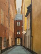 A 20th century oil on canvas laid on board, view of a narrow street in a gilt frame. H.51 W.40cm