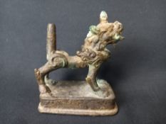 A 19th century Tibetan bronze Kylin or foo dog raised on a stepped plinth base. h.8.5 L.7.5cm