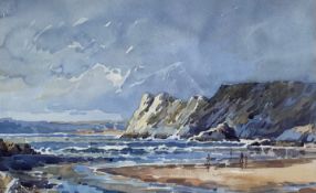 A 20th century watercolour depicting figures on a beach in a rocky coastal landscape, signed to