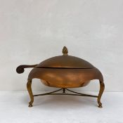 A 20th century copper chafing dish in three parts with a flame finial and scrolled handle raised