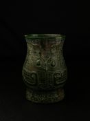 An archaistic Chinese Ming style spinach jade brush pot of baluster form carved with an abstract