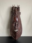 A large West African possibly Nigerian carved hardwood Yoruba mask. L.66cm