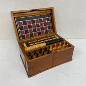 A C.1900 games compendium to include chess, whist, chequers, dice and others in a fitted oak box. H.