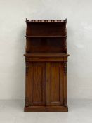 A 19th century mahogany chiffonier having a superstructure comprised of three open shelves with an