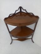 A Georgian mahogany corner occasional table having an open-work gallery back on a bow-fronted top