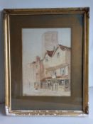 An early 20th century watercolour study of figures on a village high street with a church in the