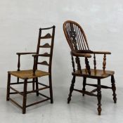 Two 19th century armchairs to include an elm ladderback elbow chair with rush seat raised on