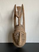 A 19th century West African carved palm tree tribal Bird Dance mask from Mali having a human face