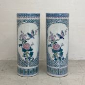 A pair of contemporary Chinese umbrella stands each of cylindrical form with figural vignettes